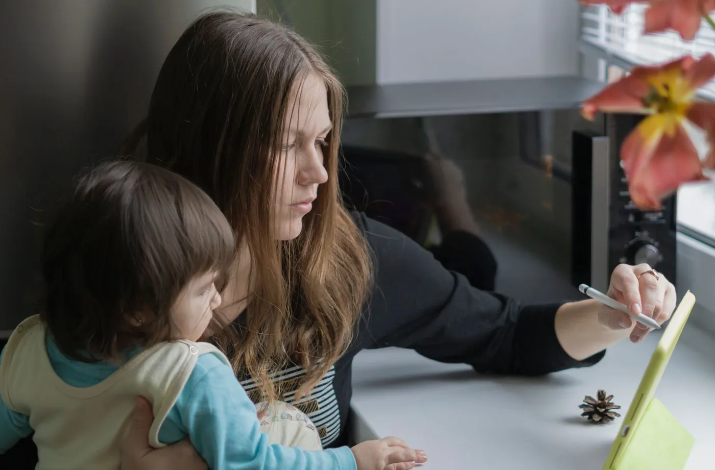 A parent and child using a device together, calmly